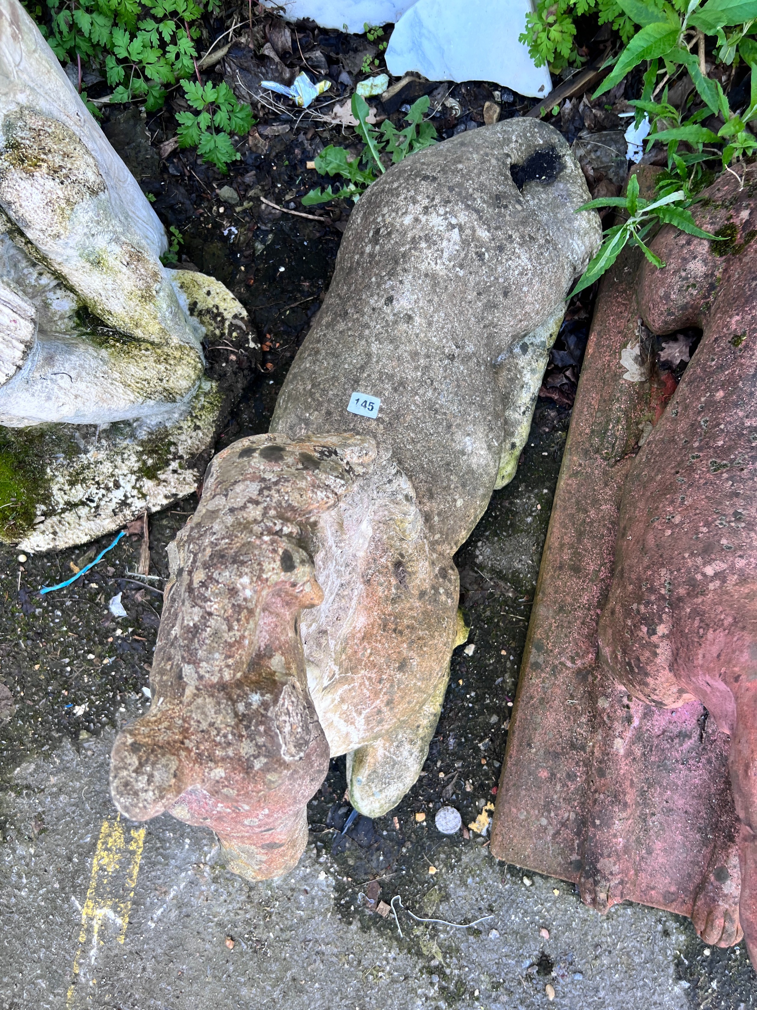 A reconstituted stone recumbent horse, height 55cm *Please note the sale commences at 9am.